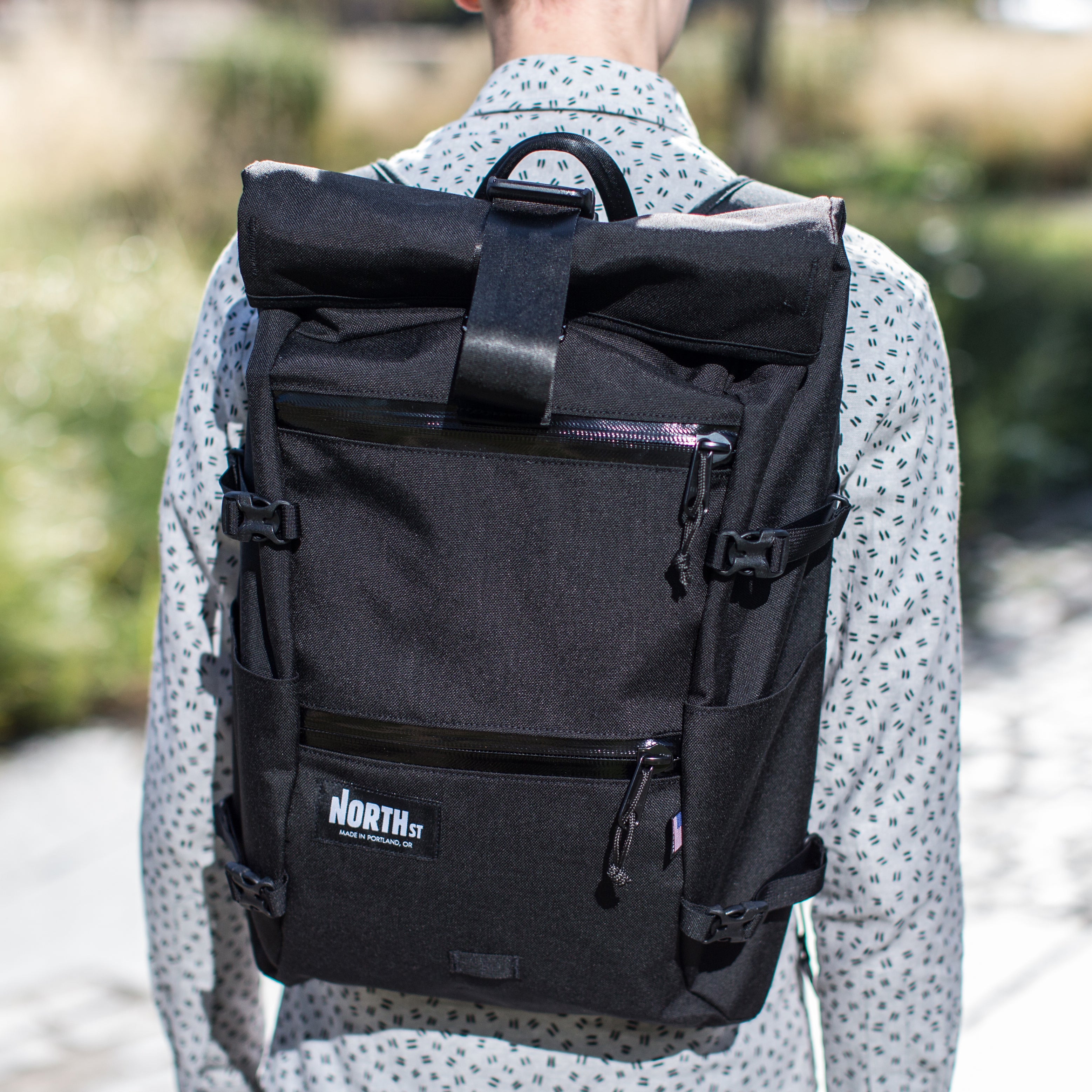 man wearing black backpack closeup