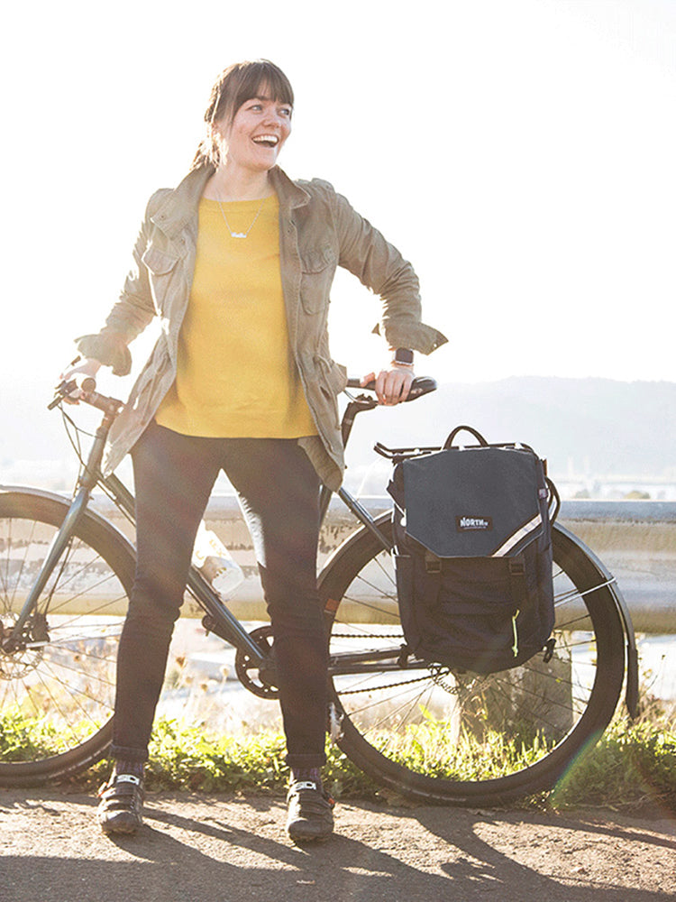 Woman cyclist standing with her bike and a Morrison Backpack Pannier - North St Bags all-groups