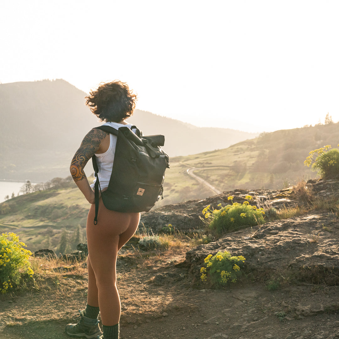 Woman enjoying a view on a mountain trail while wearing a Flanders Backpack - North St. Bags all-groups