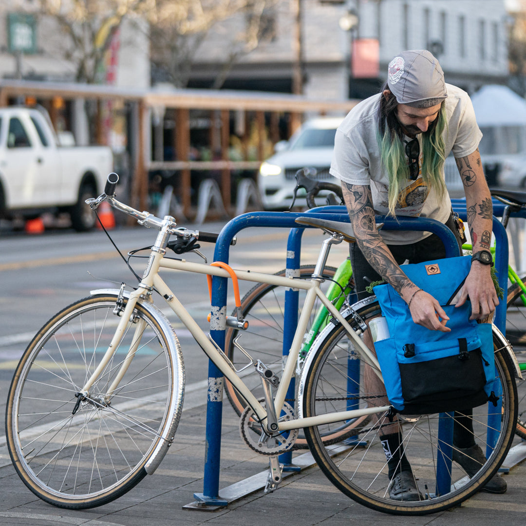 Guy closing flap on backpack pannier. Morrison Backpack Pannier - North St. Bags all-groups