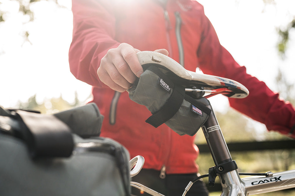 Tool roll installed under a saddle on a gravel bike. - North St. Bags all-groups