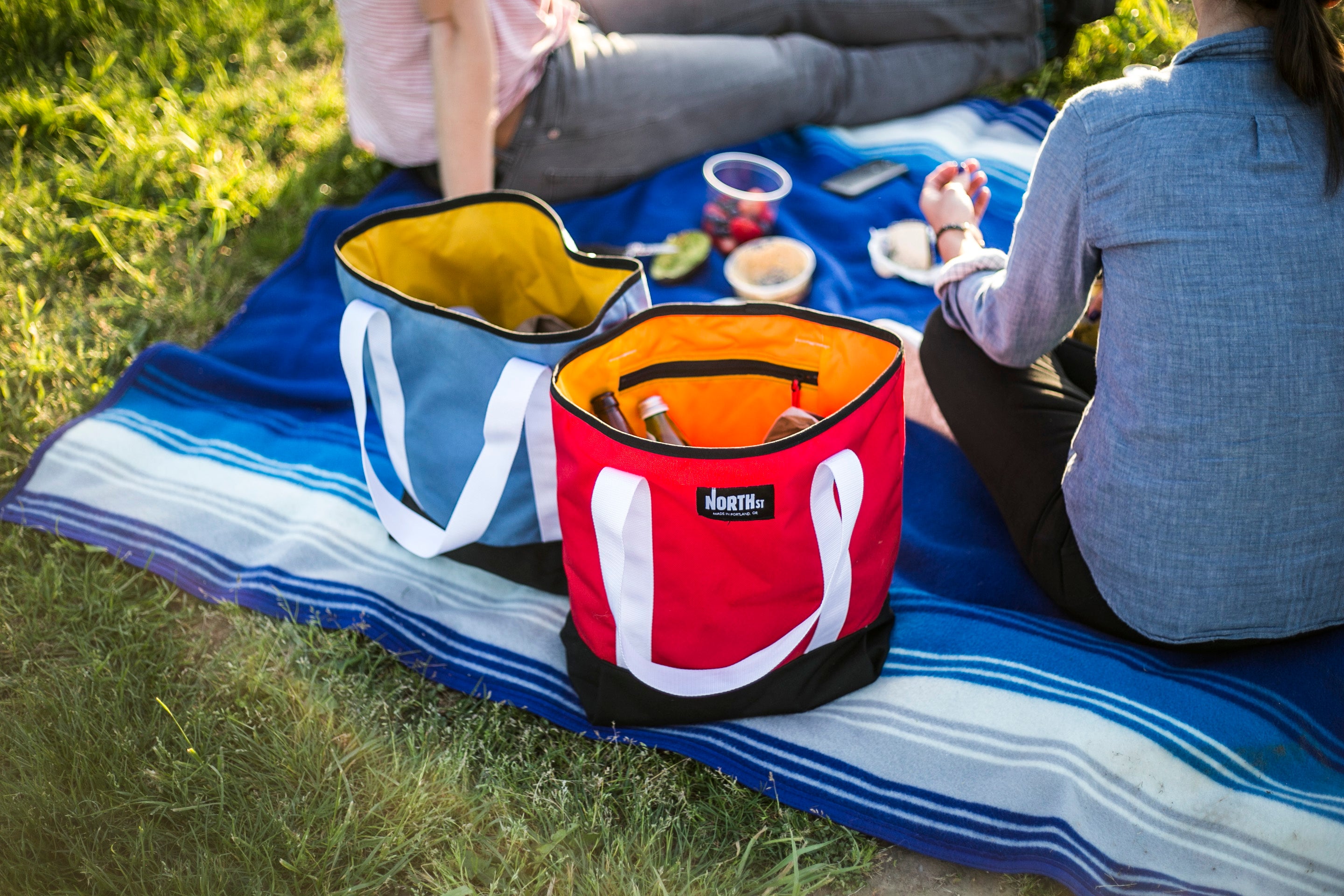 Couple on a picnic in a park with snacks and tote bags. - North St Bags  all-groups