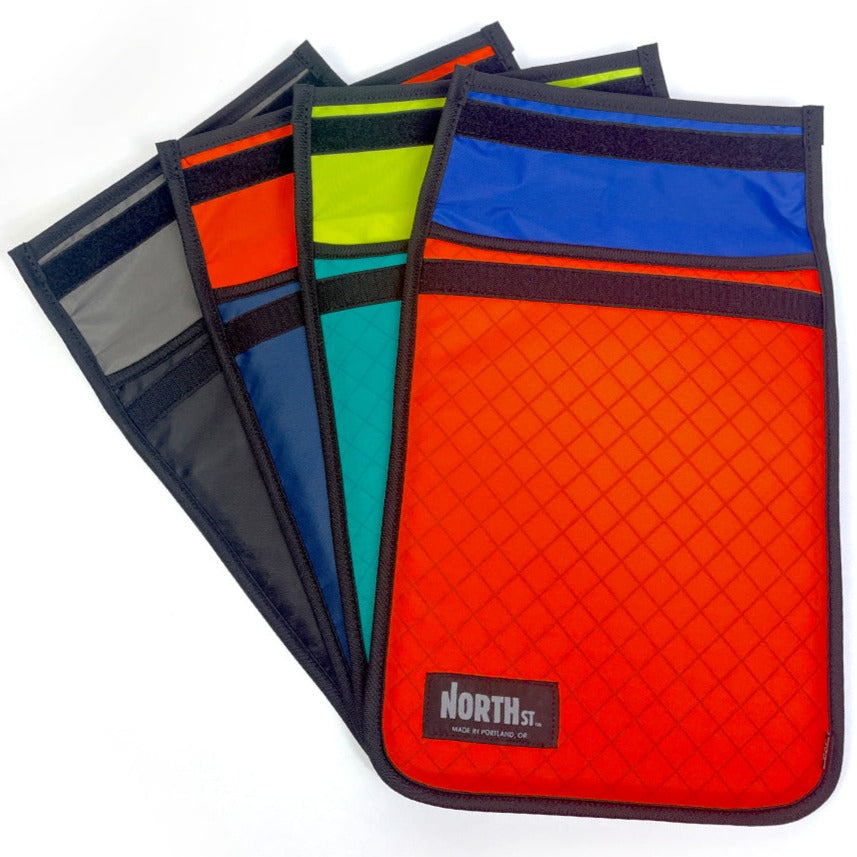 Array of four Laptop Sleeves in orange, teal, blue and black.  - North St. Bags all-groups