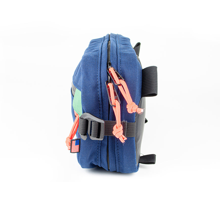 side view of sling pack by North St in midnight and green