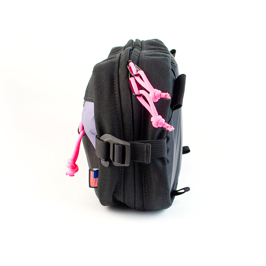 side view of sling pack by North St in black and plum