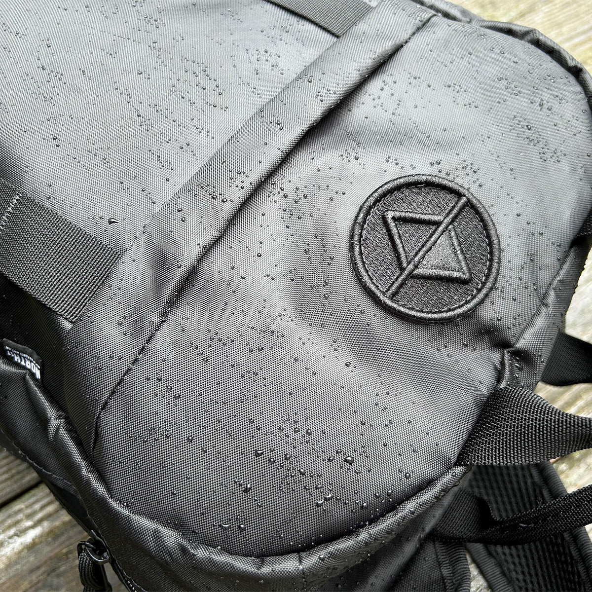 Closeup shot of patch and water drops on the front of a Vancouver Daypack - North St. Bags all-groups