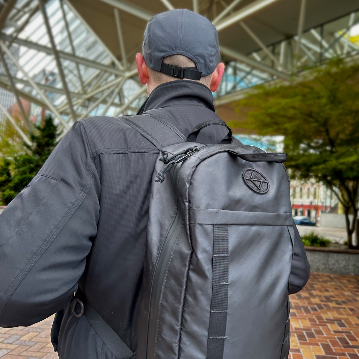 Man walking through city park with a Vancouver Daypack - North St. Bags all-groups