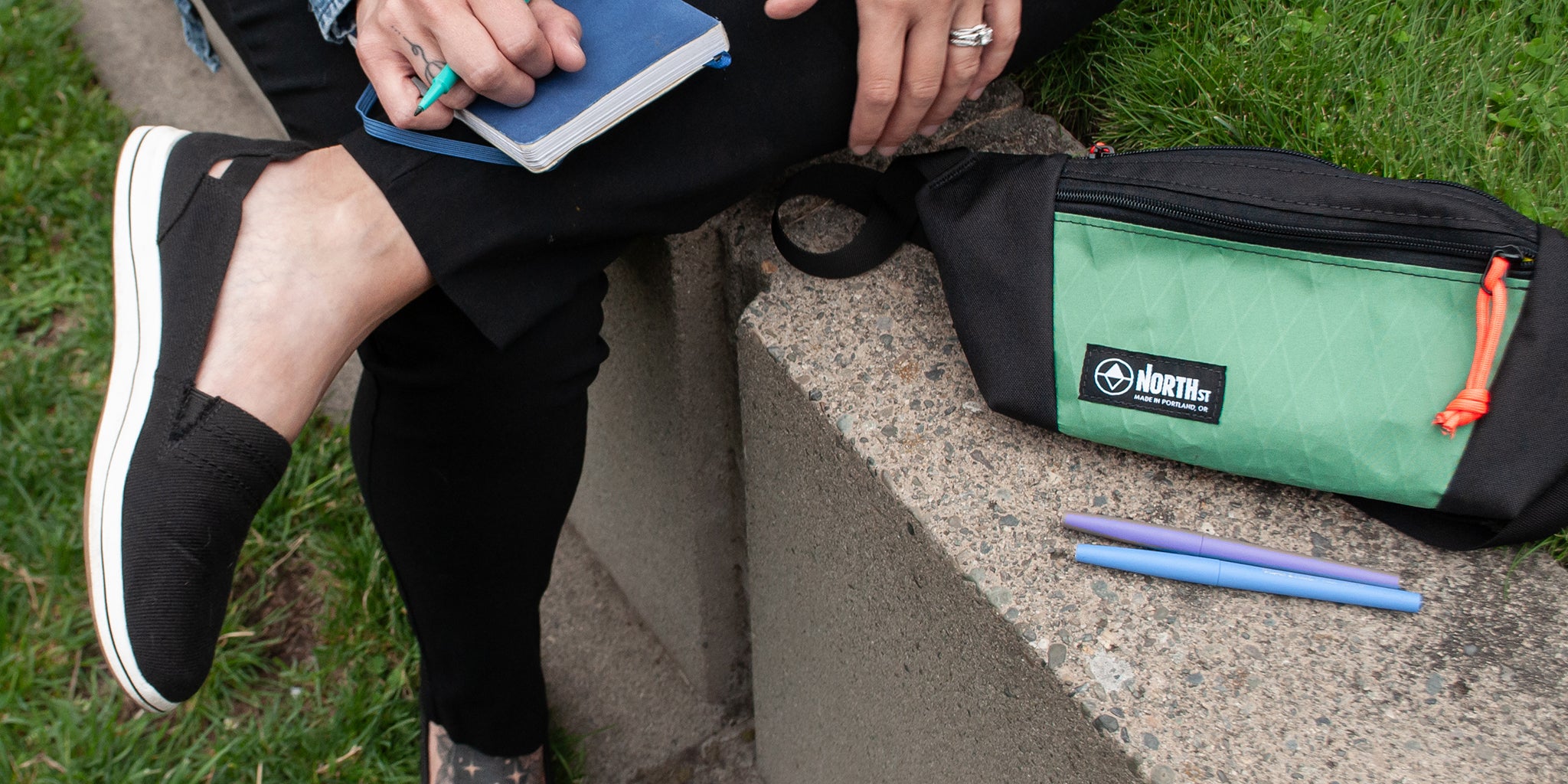 woman in part with a sketchbook and sling pack - North St Bags