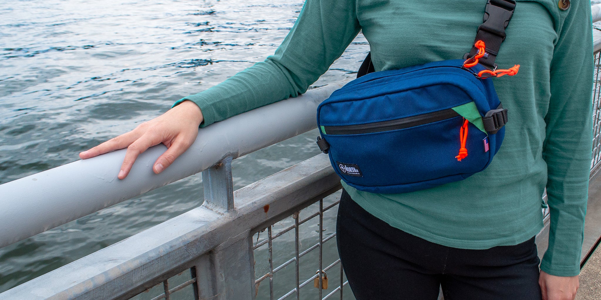 woman at the waterfront wearing a North St Sling pack